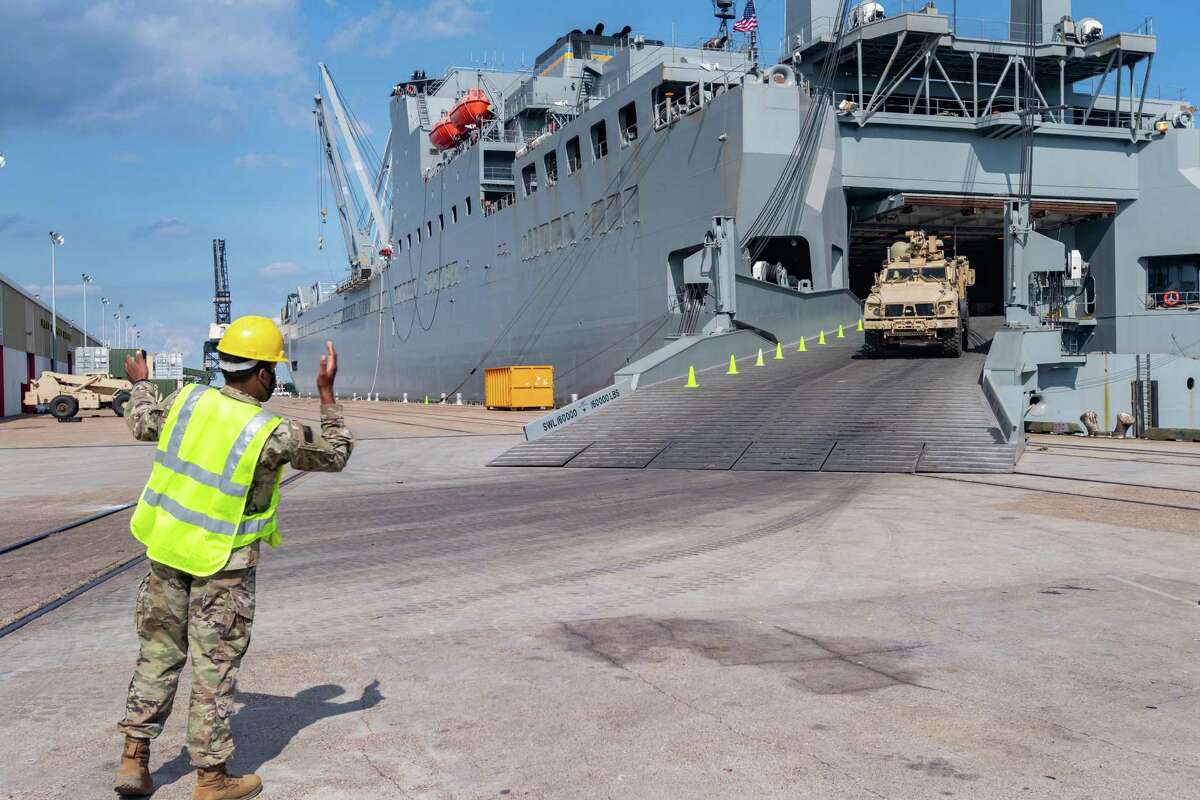 A soldier directs a vehicle disembarking from the USNS Frazier. If you're seeing a lot of soldiers and Army vehicles, on the streets of Port Arthur, do not be alarmed. About a thousand soldiers of The 7th Transportation Brigade (Expeditionary) of the US Army also known as the "Army's Navy" are unloading hundreds of vehicles, shipping containers, and helicopters from the US Naval Ship Frazier, staging them at the port. The equipment is being transferred from the 2nd Brigade Combat Team, 25th Infantry Division, Schofield Barracks, Hawaii to Fort Polk in Louisiana. The 7th Transportation Brigade, Joint Base Langley-Eustis, VA were called for a readiness exercise on August 12, 2020 to test their ability to alert, recall, and deploy the 2nd Infantry Brigade Combat Team, 25th Infantry Division under emergency conditions. Photo made on September 26, 2020. Fran Ruchalski/The Enterprise