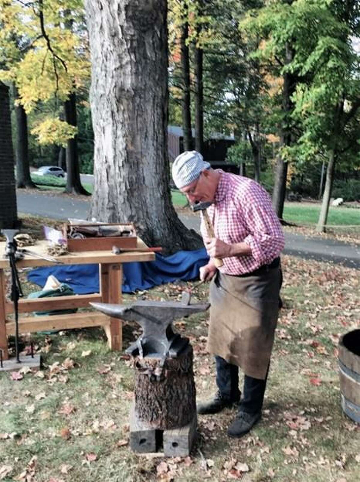 Ralph Lapidus depicts 18th-century blacksmithing in an outdoor family demonstration of the 2017 "#HandsonHistory: It Takes A Village" exhibition.