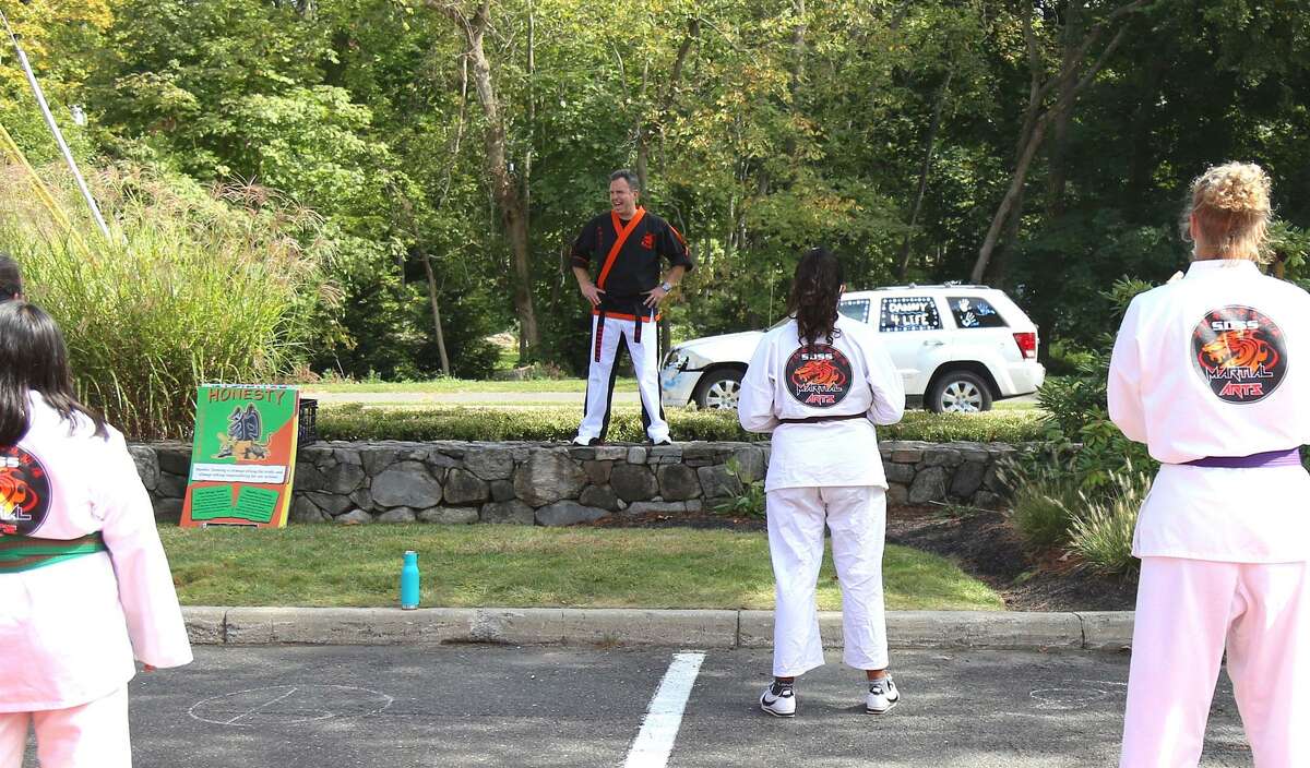 Mike Meyer, president of SDSS Martial Arts, works with students at the outdoor space the business now has available in the Wilton River Park Shopping Center.