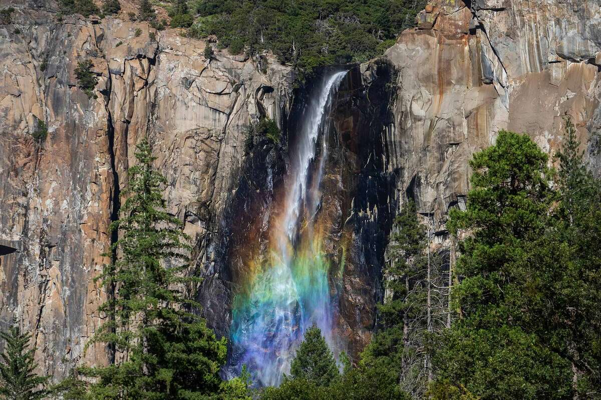 A rainbow shines through the mist at Bridalveil Falls in Yosemite National Park, Calif., on July 06, 2020.