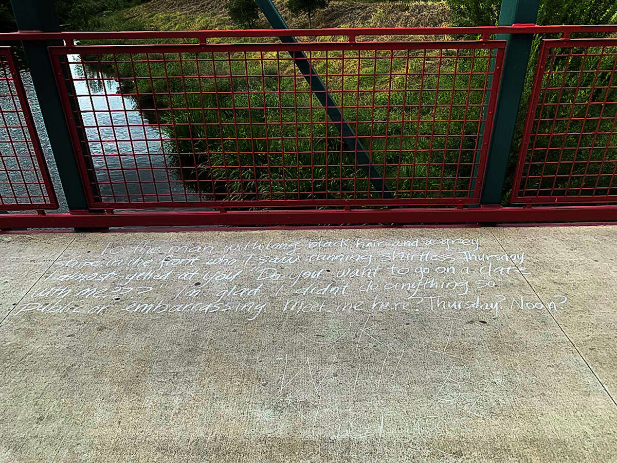 The note reads: "To the man with long black hair and a grey stripe in the front who I saw running shirtless Thursday, I almost yelled at you "Do you want to go on a date with me???" I'm glad I didn't do anything so public or embarrassing. Meet me here? Thursday? Noon?" A response faintly etched beneath the public proposal reads, "Ok, I will be here."