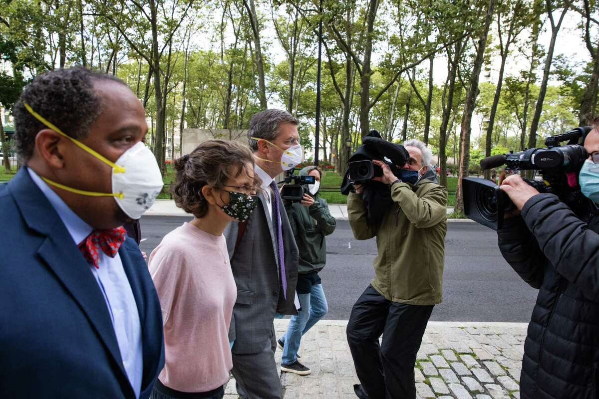 Clare Bronfman, daughter of former Seagram Chairman Edgar M. Bronfman, second left, arrives at federal court in the Brooklyn borough of New York, U.S., on Wednesday, Sept. 30, 2020. Bronfman was charged with helping finance the activities of Nxivm, an upstate New York cult accused of branding its victims and forcing them to participate in sex acts. She pleaded guilty to conspiracy charges and could spend more than two years in federal prison. Photographer: Paul Frangipane/Bloomberg