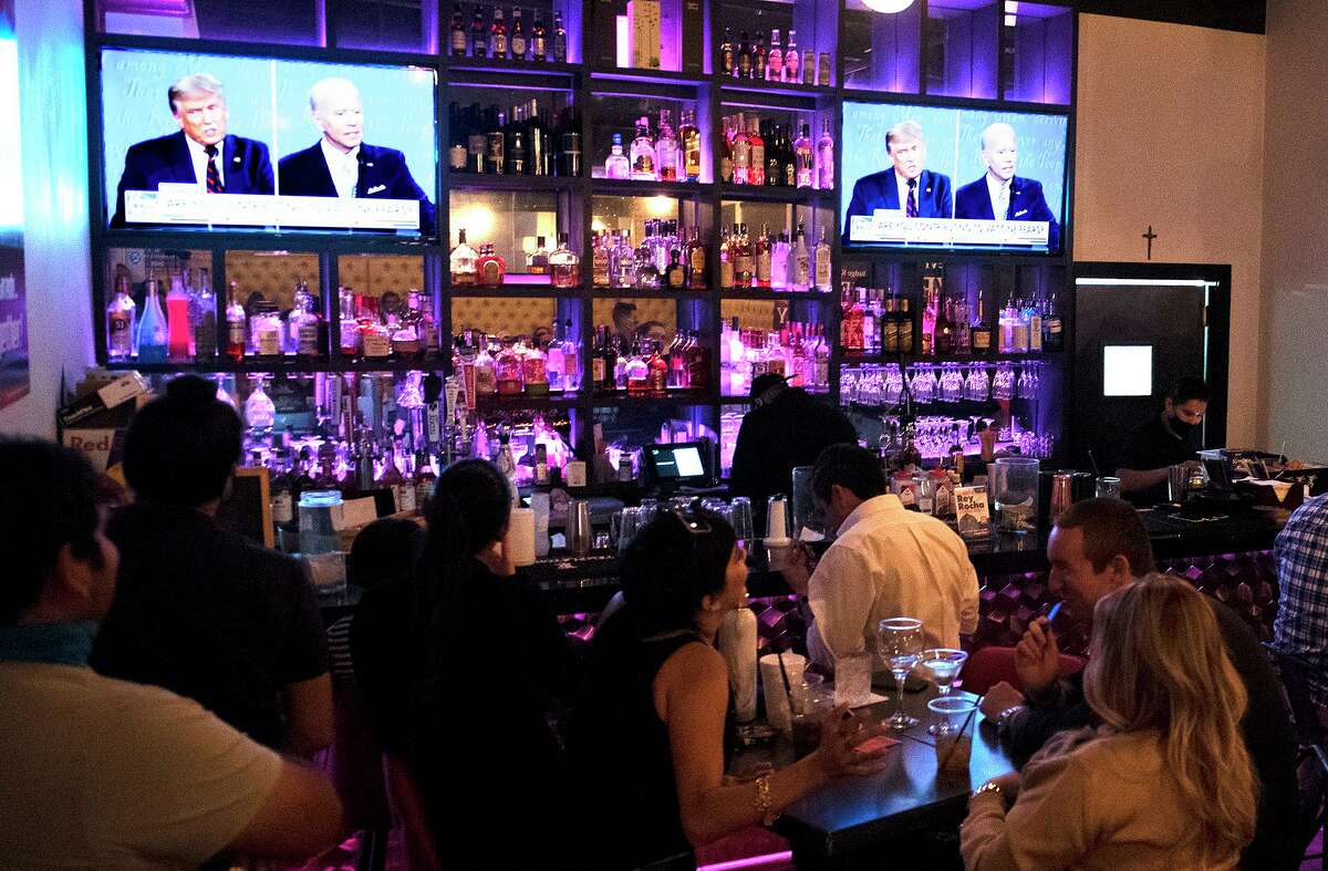 Potential voters and their family gather at Rocha's Bar and Grill to watch the presidential debate, Tuesday, Sep. 29, 2020.