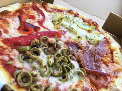 The Four Seasons pizza is quartered with one topping per section — artichoke hearts, prosciutto, roasted red peppers or green olives.