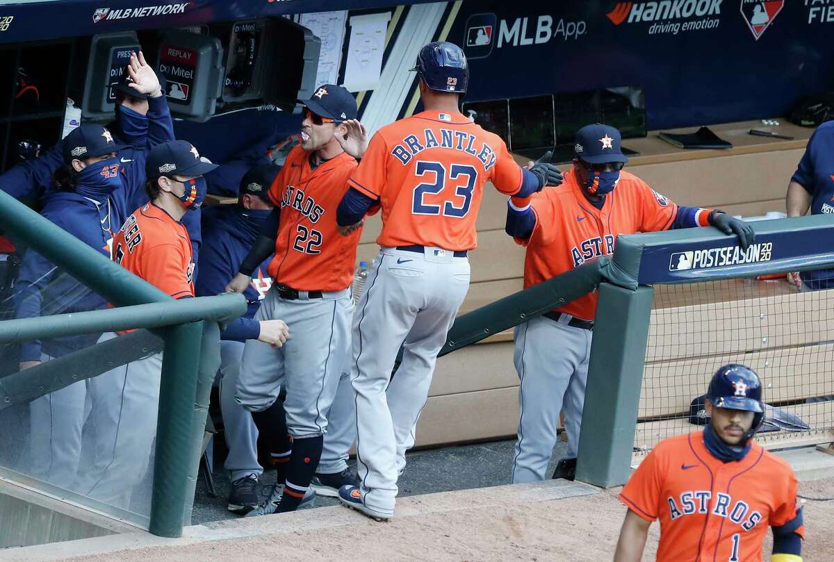 The Astros 'Michael Brantley is congratulated after scoring on Kyle Tucker's RBI single during the fourth inning of Game 2 on Wednesday at Target Field in Minneapolis.