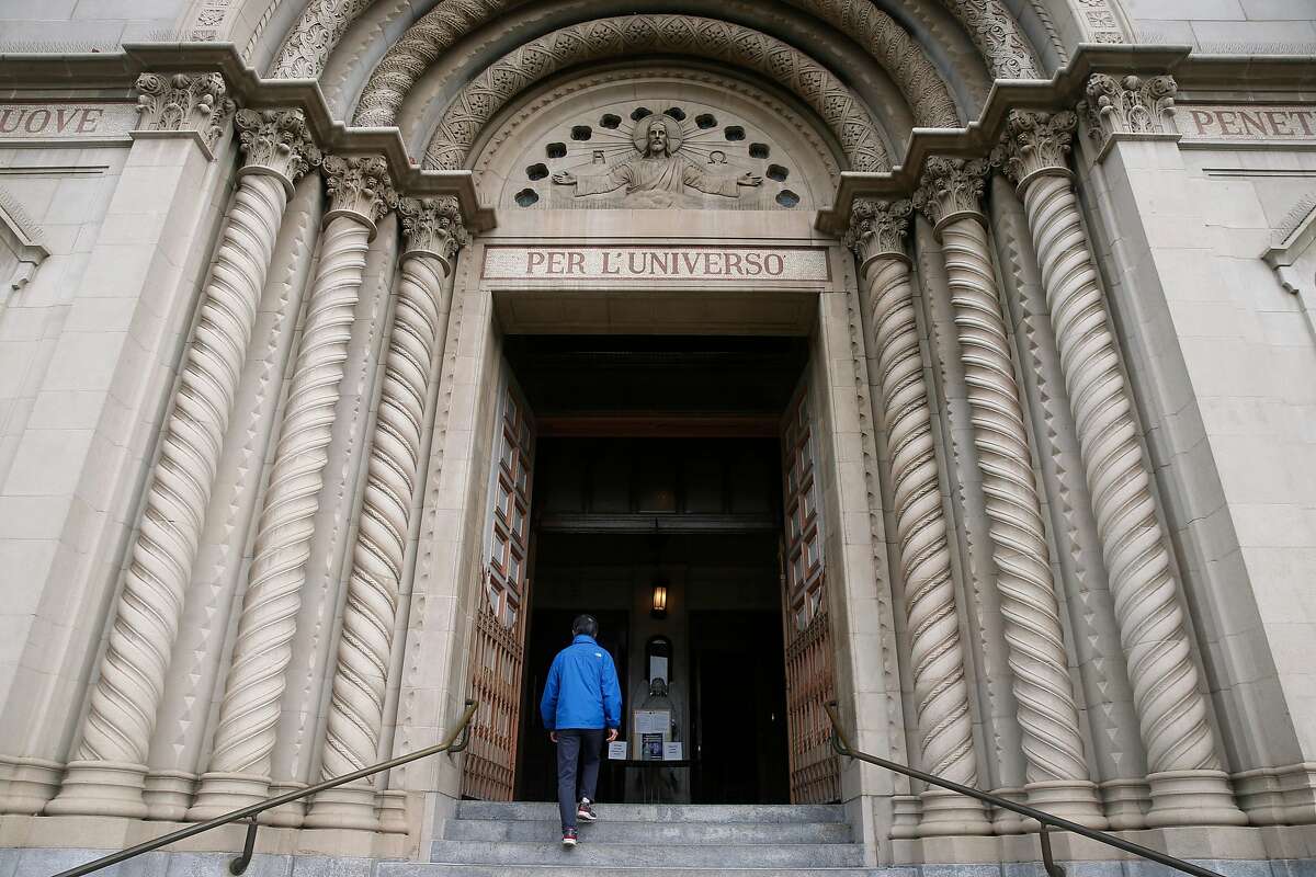 Albert Mung arrives for the 9 a.m. Mass at Sts. Peter and Paul Church in San Francisco.