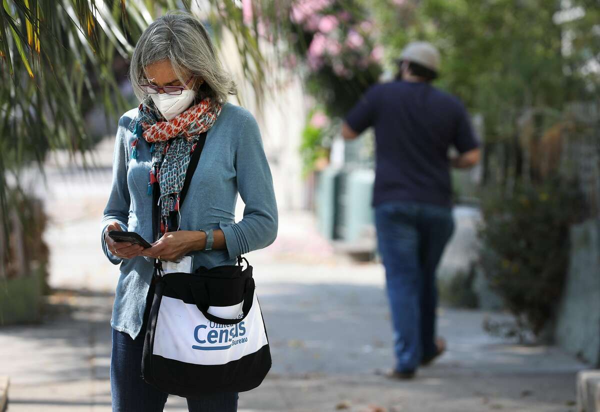 Census enumerator Amy Tanner checks her phone on San Jose Avenue in San Francisco on Sept. 17.