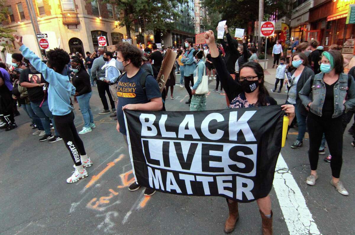 Hundreds of Black Lives Matter protesters march along Chapel Street to honor Breonna Taylor in New Haven, Conn., on Thursday Sept. 24, 2020. The march is in response to no charges being brought against the police officers involved in her death in Louisville, Kentucky.