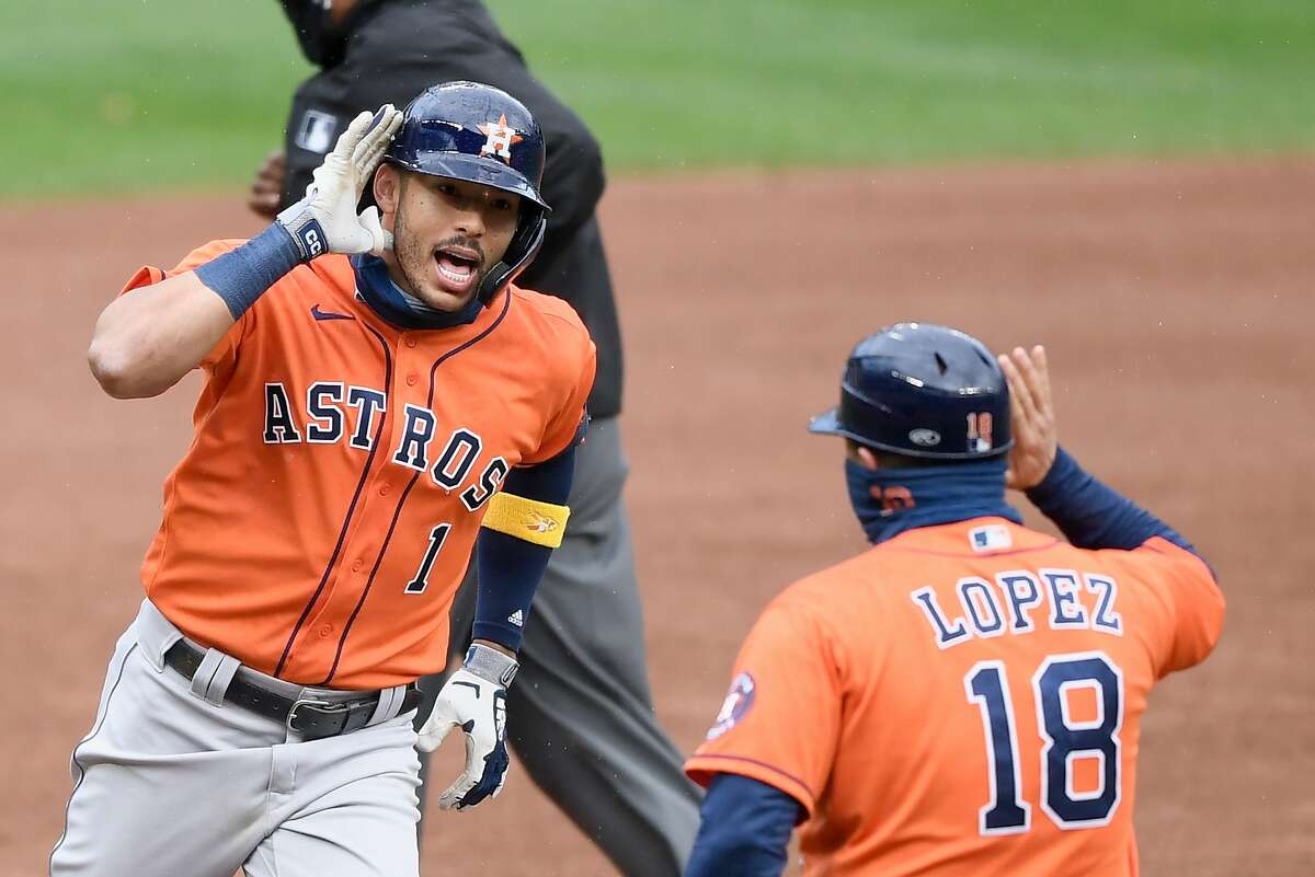 Astros shortstop Carlos Correa, with third-base coach Omar Lopez, silenced Twins fans in Minneapolis after his big homer.