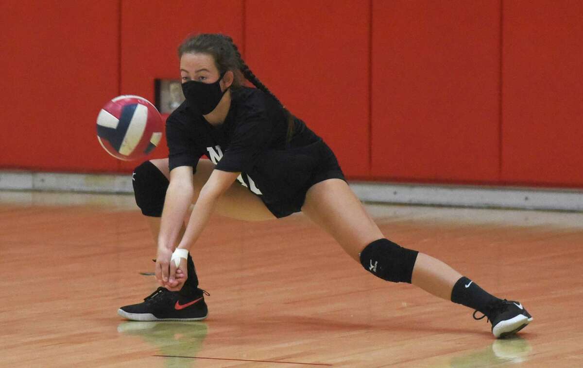 New Canaan senior co-captain Alex Gillespie gets low for a dig during a preseason volleyball practice at NCHS on Friday, Sept. 25, 2020.