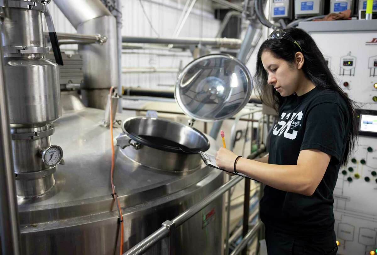 Michelle Ramirez looks over paperwork at Southern Star Brewery in Conroe, Friday, Sept. 25, 2020. Ramirez officially became a brewer two years ago after her mother asked Southern Star if they were hiring.