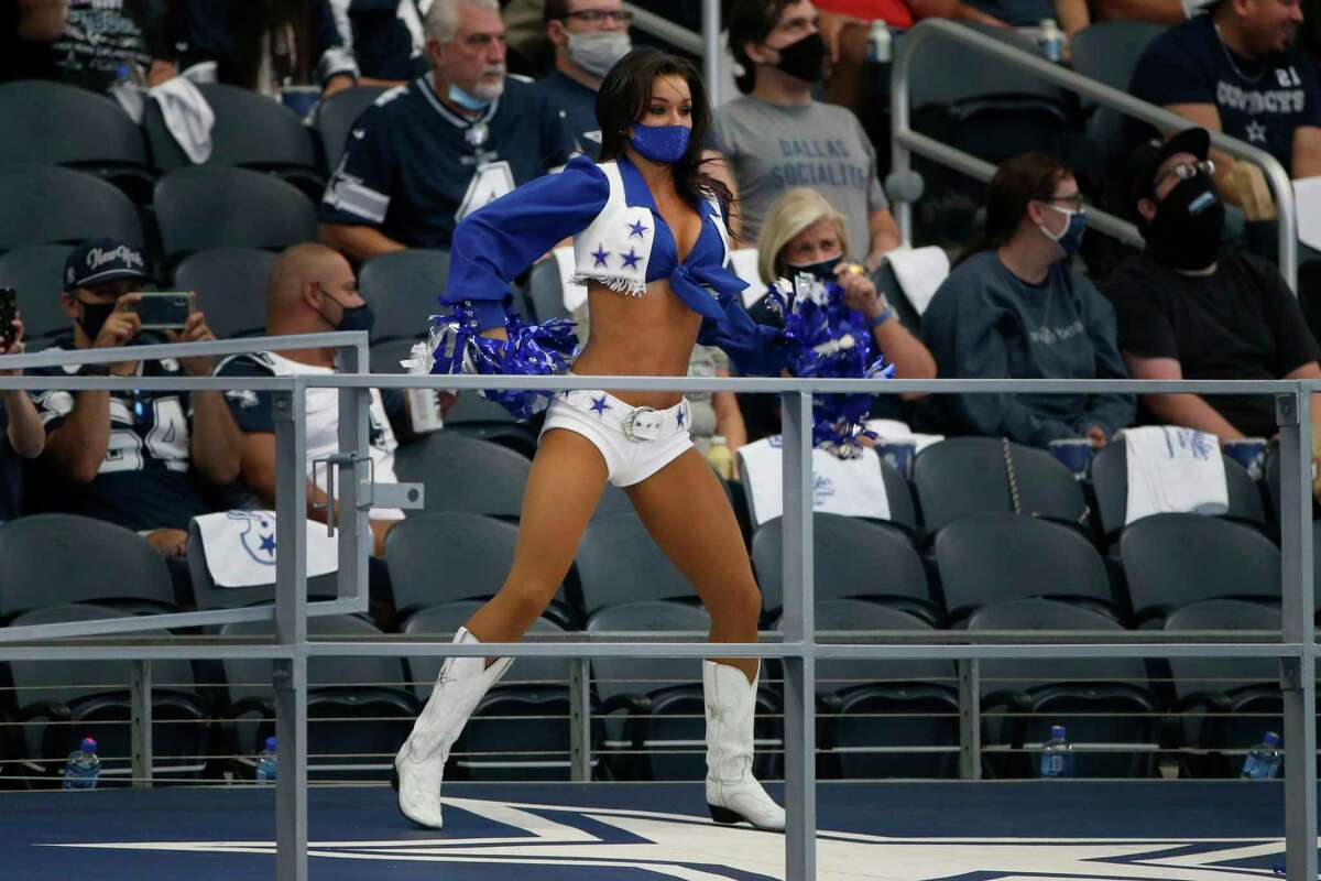 A member of the Dallas Cowboys Cheerleaders performs during the first half of an NFL football game against the Atlanta Falcons in Arlington, Texas, Sunday, Sept. 20, 2020. (AP Photo/Michael Ainsworth)
