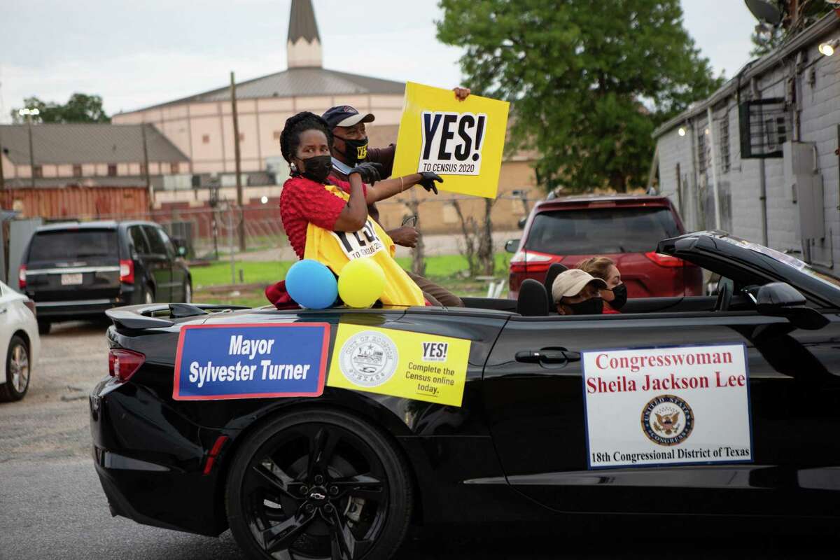 Representative Sheila Jackson Lee and Mayor Sylvester Turner raise a “Yes to Census 2020” sign as they cruise through Third Ward in the Census Bureau vehicle parade on Sept. 19, 2020.