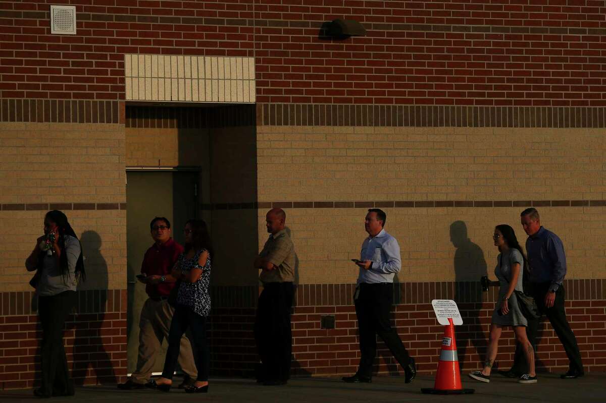 Voters wait in line to cast their ballots at James Bowie Middle School Tuesday, Nov. 6, 2018, in Richmond. Texas.