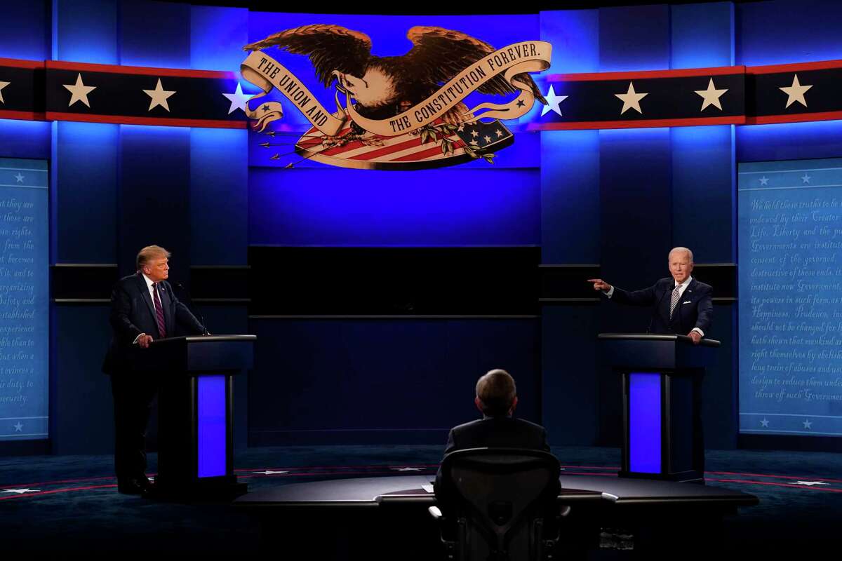 President Donald Trump, left, and Democratic presidential candidate former Vice President Joe Biden, right, during the first presidential debate Sept. 29, 2020, in Cleveland, Ohio. Seated in the center is moderator Chris Wallace of Fox News.