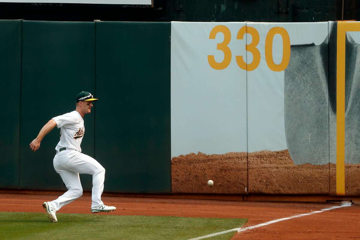 Oakland Athletics' Mark Canha chases down a double by Chicago White Sox' Tim Anderson in 2nd inning during Game 3 of Wild Card Series at Oakland Coliseum in Oakland, Calif., on Thursday, October 1, 2020.