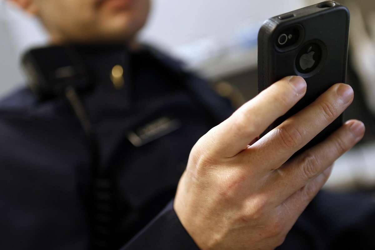 A police officer checks Twitter on his mobile phone. An unknown number of Bay Area residents — even in areas spared by the recent rash of wildfires — received erroneous emergency alerts Thursday warning of imminent fire danger. The blunder forced municipalities all over the Bay Area to send follow-up messages attempting to clarify that no such danger was present.