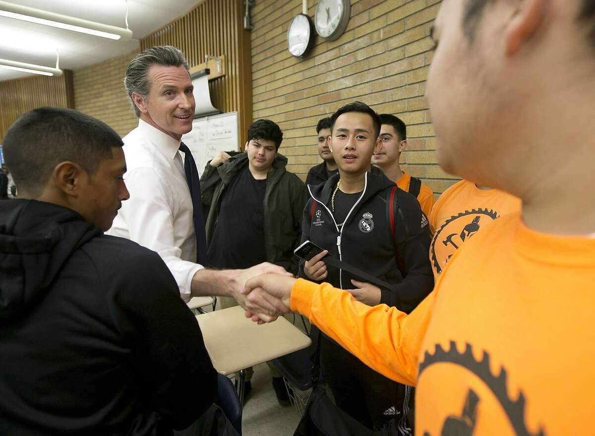 Then-Lt. Gov. Gavin Newsom is greeted by students during a visit to Luther Burbank High School in Sacramento in November 2017.