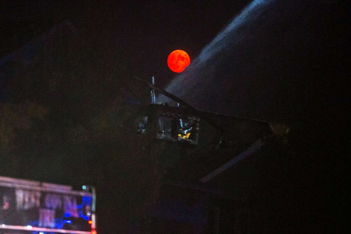 The moon rises over firefighters helping to put out whats left of the Glass Fire in the Skyhawk neighborhood on September 30, 2020 in Santa Rosa, CA.
