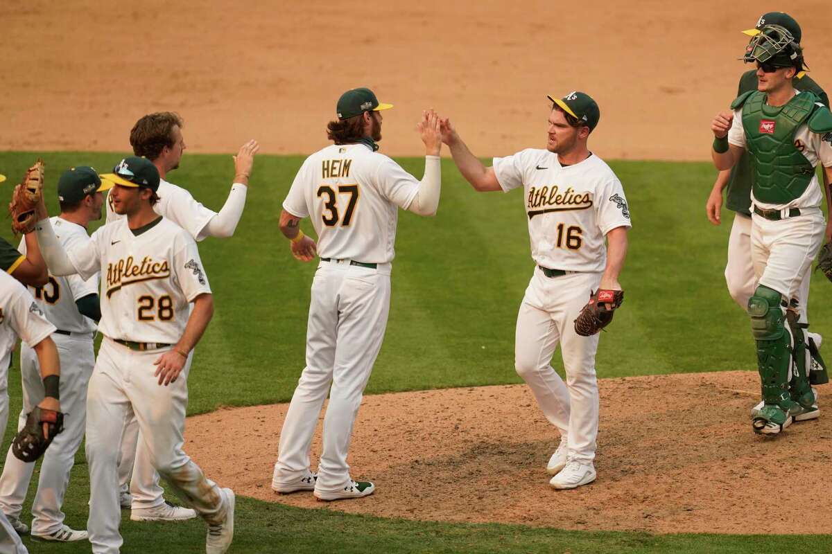 Closer Liam Hendricks (16) had the A’s celebrating a playoff series win for the first time since 2006 after he preserved Thursday’s 6-4 victory over the White Sox at the Oakland Coliseum.