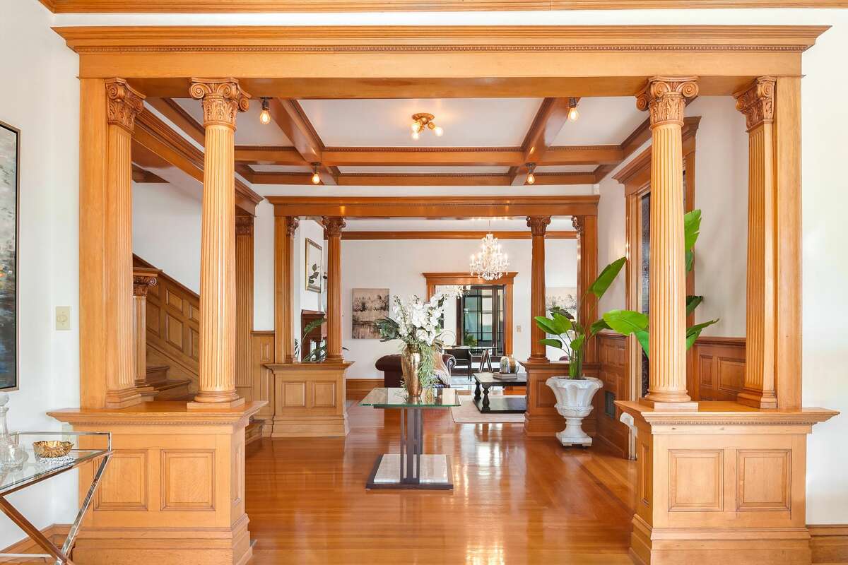 Inside, the home features wood floors, beams, paneling and accents. 