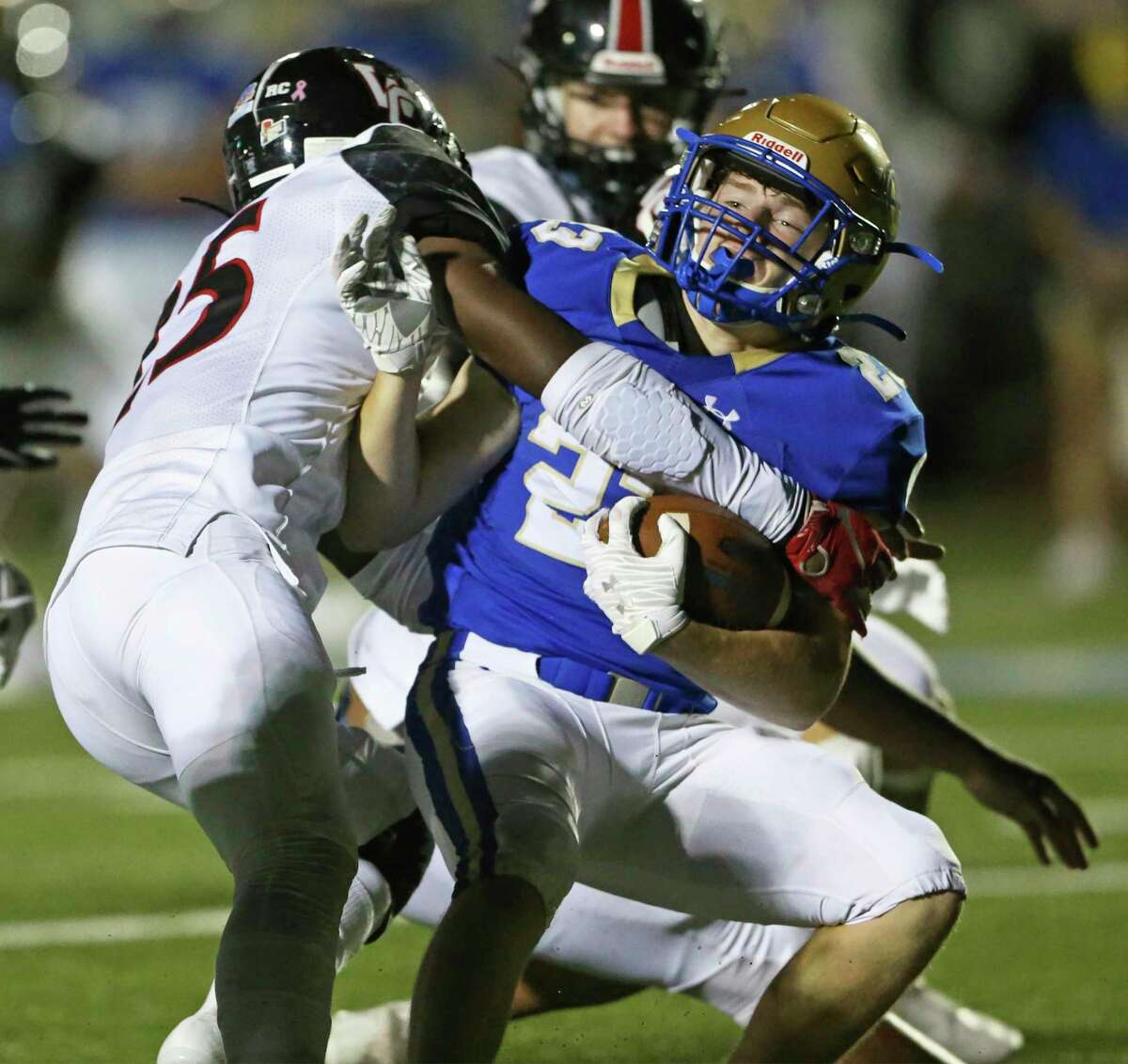 Mule running back George Flesher is brought down hard by Marshall Perez (25) as Alamo Heights hosts Churchill at Commalander Stadium on Oct. 1, 2020.