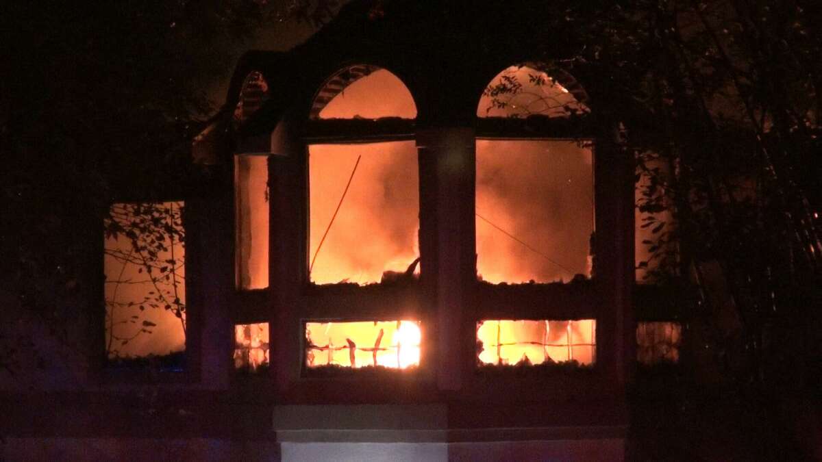 The inside of a house off Lake Conroe in Willis is seen on fire early Friday, Oct. 2, 2020. A woman's remains were found inside.