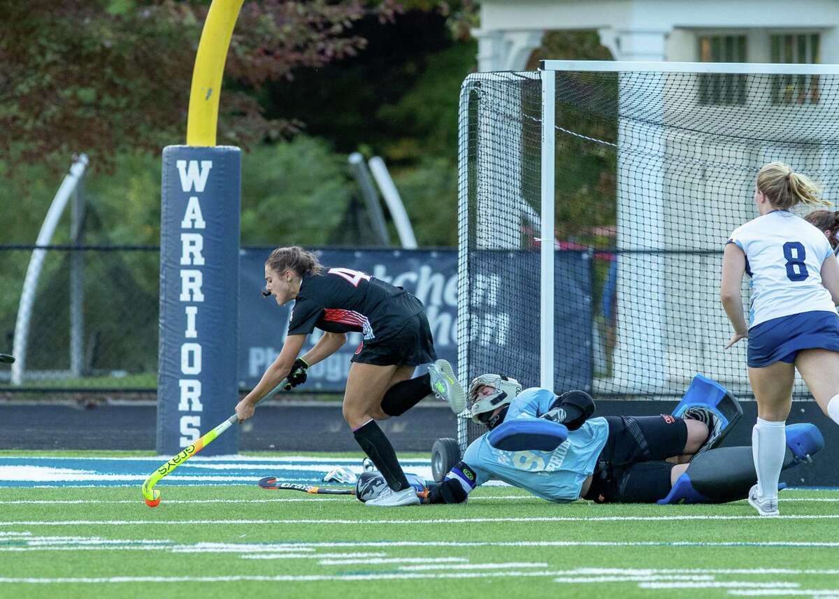 Aerin Krys gets ready to score one of her three goals in the Ridgefield field hockey team's 5-1 win over Wilton on Thursday.