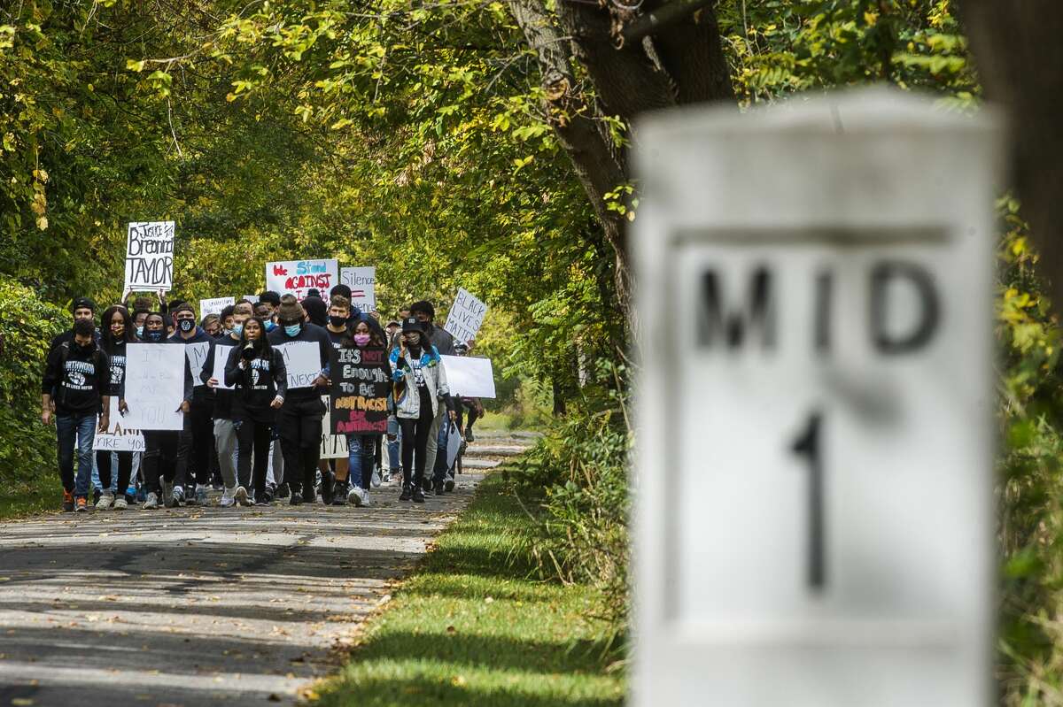 Dozens of Northwood University students and other local supporters make the long trek from their campus to downtown Midland in the name of racial justice on Friday, Oct. 2, 2020. Organized by the Black Student Union at Northwood, the "Racial Injustice Community March" was the group's attempt to educate the Midland public and raise awareness of the many hardships Black Americans face. (Katy Kildee/kkildee@mdn.net)