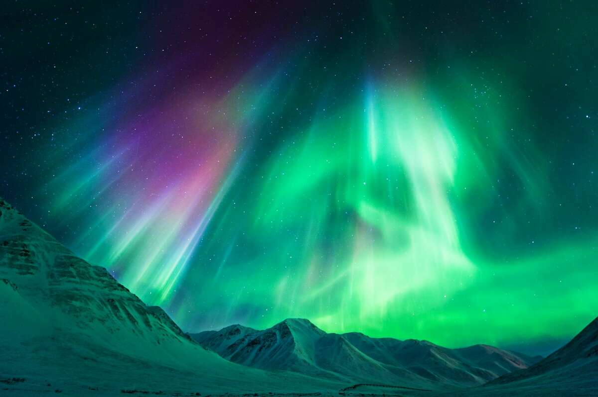 Stong geomagnetic Aurora Borealis (Northern Lights) above Alaskan mountains, Atigun Pass - Dalton highway (North of Fairbanks), Alaska, USA.