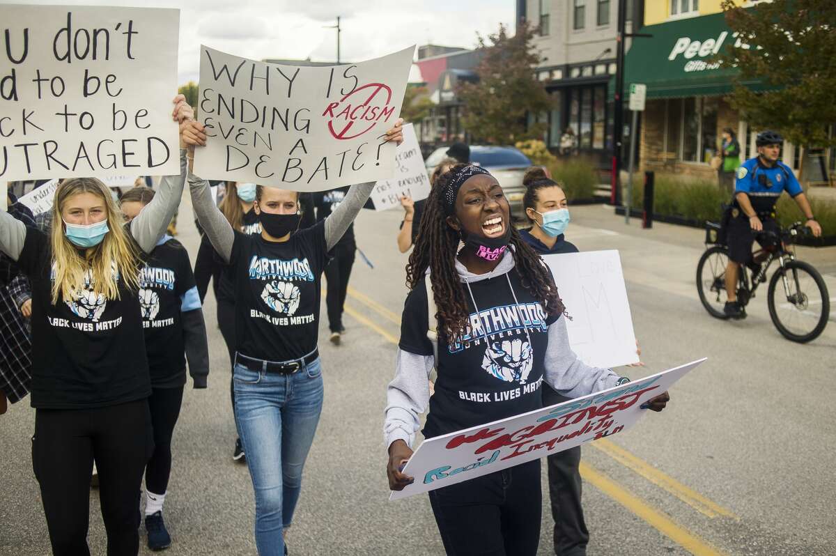 Jayla Strickland, a Northwood University student and athlete on the women's basketball team, leads a chant while marching with dozens of fellow Northwood students and other local supporters through downtown Midland in the name of racial justice on Friday, Oct. 2, 2020. Organized by the Black Student Union at Northwood, the "Racial Injustice Community March" was the group's attempt to educate the Midland public and raise awareness of the many hardships Black Americans face. (Katy Kildee/kkildee@mdn.net)