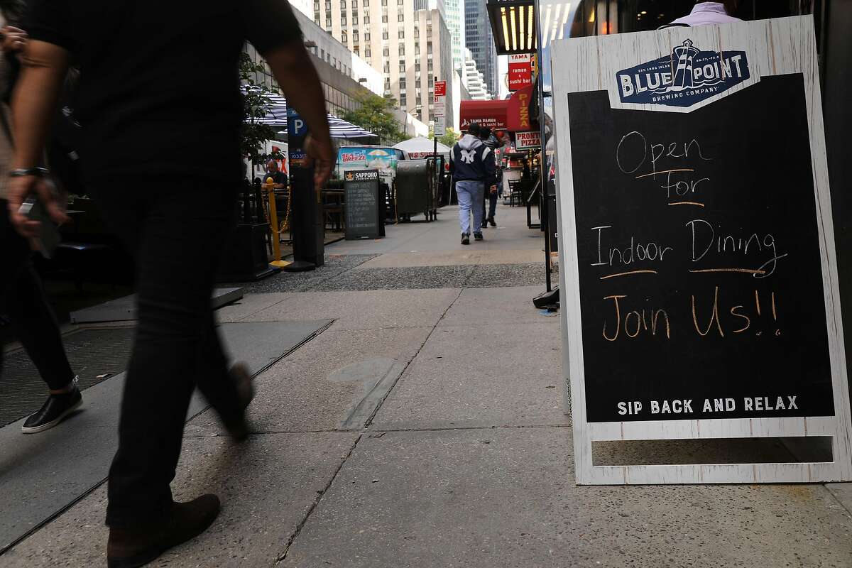 NEW YORK, NEW YORK - SEPTEMBER 30: Restaurant signs advertise indoor dining along a Manhattan street as New York City restaurants are allowed to open their doors to 25 percent capacity on September 30, 2020 in New York City. As some customers return to indoor dining, they will be met with plastic partitions, hand sanitizer, masks and gloves. The city says that 50 percent capacity will follow shortly. (Photo by Spencer Platt/Getty Images)