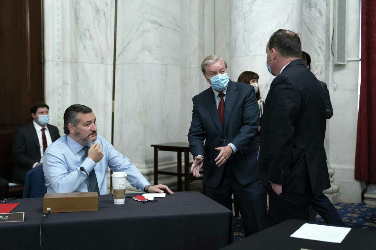 Senator Lindsey Graham, a Republican from South Carolina and chairman of the Senate Judiciary Committee, center, speaks to Senator Ted Cruz, a Republican from Texas, left, and Senator Mike Lee, a Republican from Utah, ahead of a business meeting in Washington, D.C., U.S., on Thursday, Oct. 1, 2020. Democrats on the Senate Judiciary Committee plan to ask Supreme Court nominee Amy Coney Barrett during her confirmation hearings whether she would refuse to take part in matters related to the election if she’s confirmed in time, according to a Senate Democratic aide. Photographer: Stefani Reynolds/Bloomberg