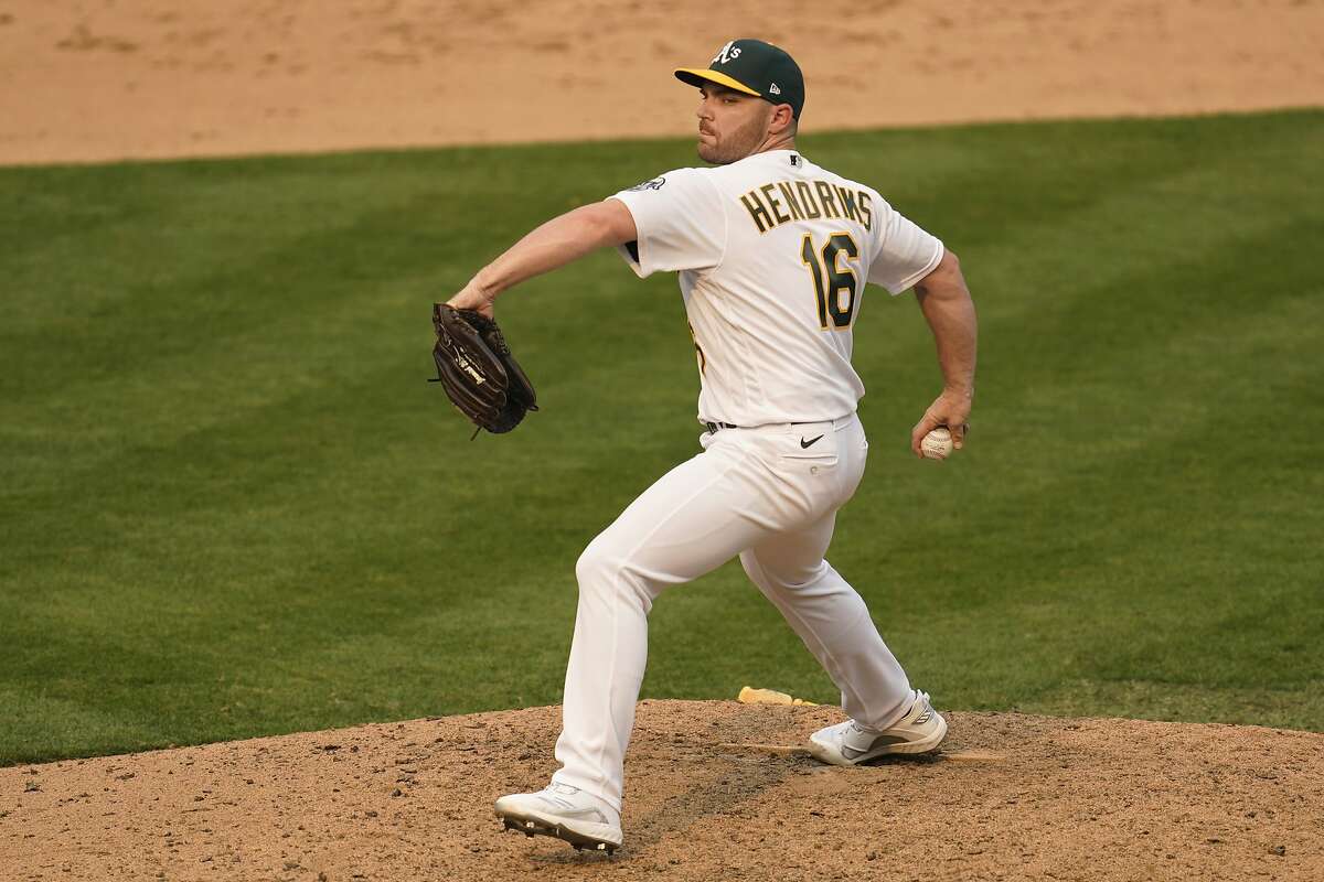 Oakland Athletics' Liam Hendriks pitches to a Chicago White Sox batter during the ninth inning of Game 3 of an American League wild-card baseball series Thursday, Oct. 1, 2020, in Oakland, Calif. (AP Photo/Eric Risberg)