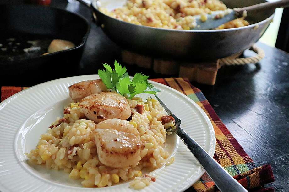 Seared scallops on top of corn and chorizo risotto is an easy and satisfying fall dish. (Gretchen McKay/TNS) / Pittsburgh Post-Gazette