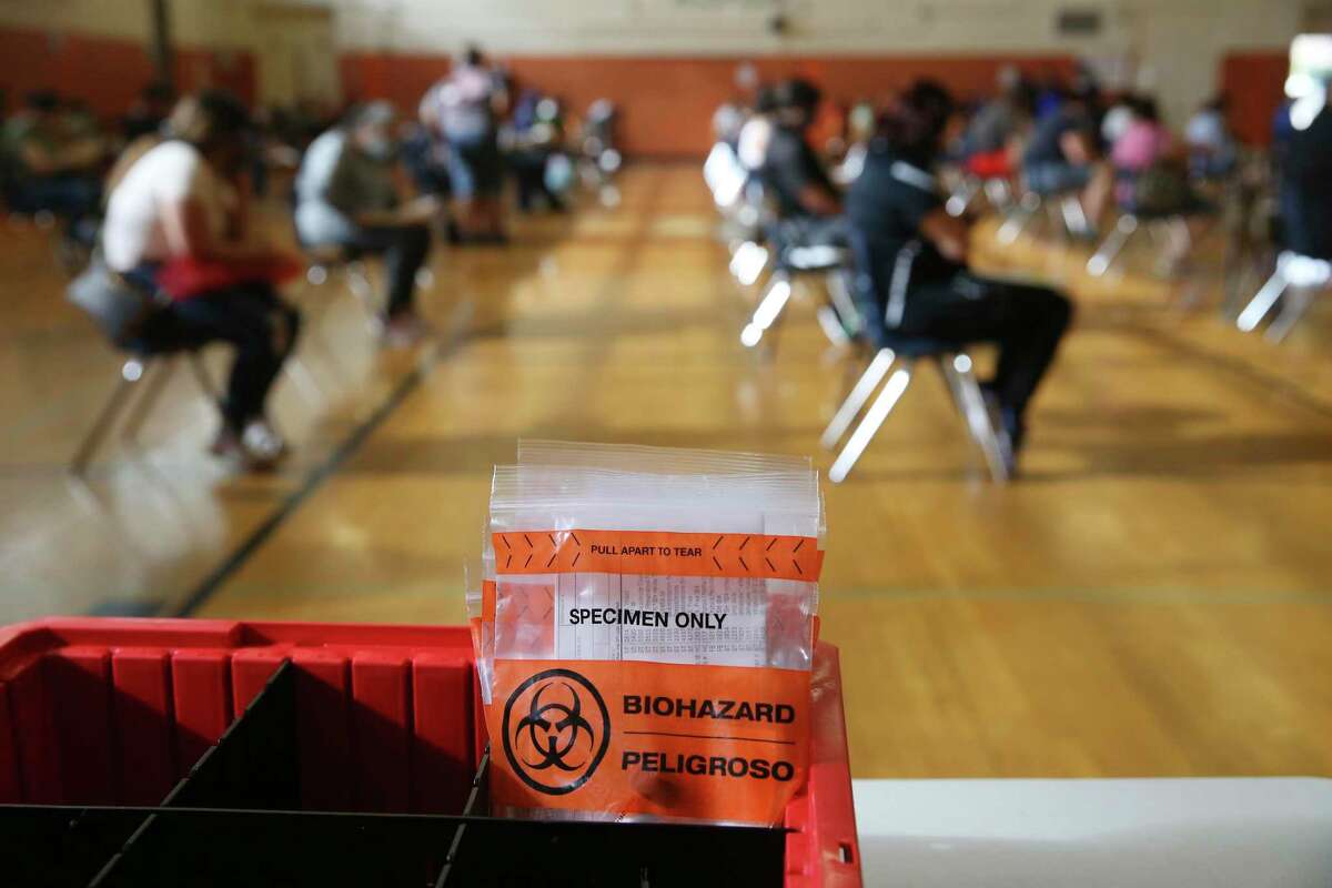 COVID-19 swab packets are prepared at a walk-up testing site at Burbank High School in San Antonio.