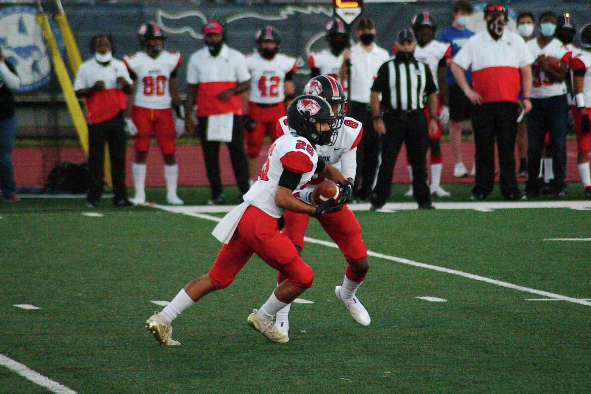Clear Brook's Adrian Castillo (26) takes the handoff from Cameron McCalister (8) against Friendswood last week. The Wolverines open District 24-6A play Friday against Clear Lake.