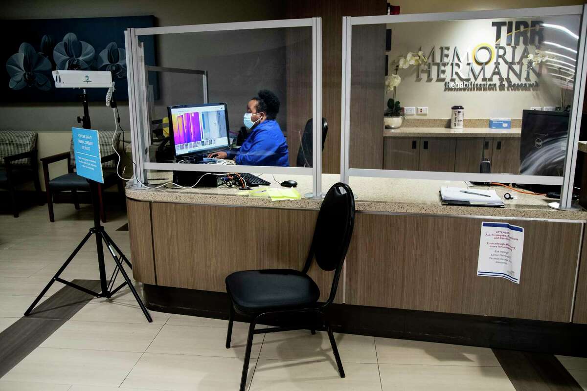 The front reception desk, with a thermal scanner being used is shown at TIRR Memorial Hermann is shown on Thursday, July 23, 2020 in Houston.