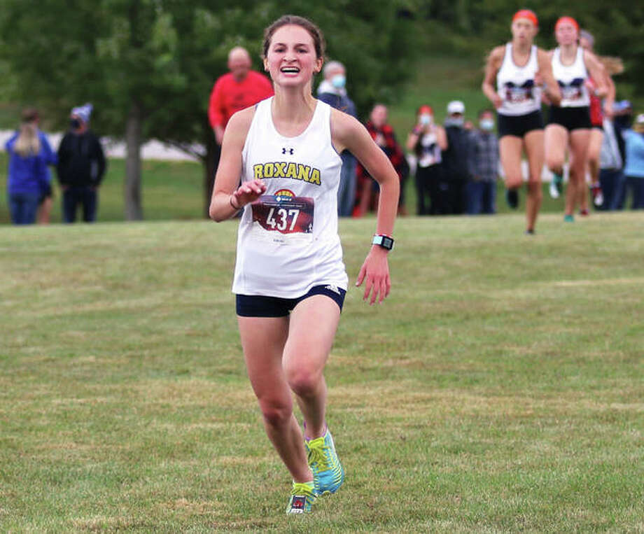 Roxana sophomore Gabrielle Woodruff pushes to the finish line in a race with the clock ticking toward 20 minutes Saturday morning in Highland’s Alhambra Invitational cross country meet at Fireman and Legion Park in Alhambra. Woodruff finished in 19 minutes, 57.58 seconds to place sixth in the girls race and set a personal record for three miles. Photo: Greg Shashack / The Telegraph