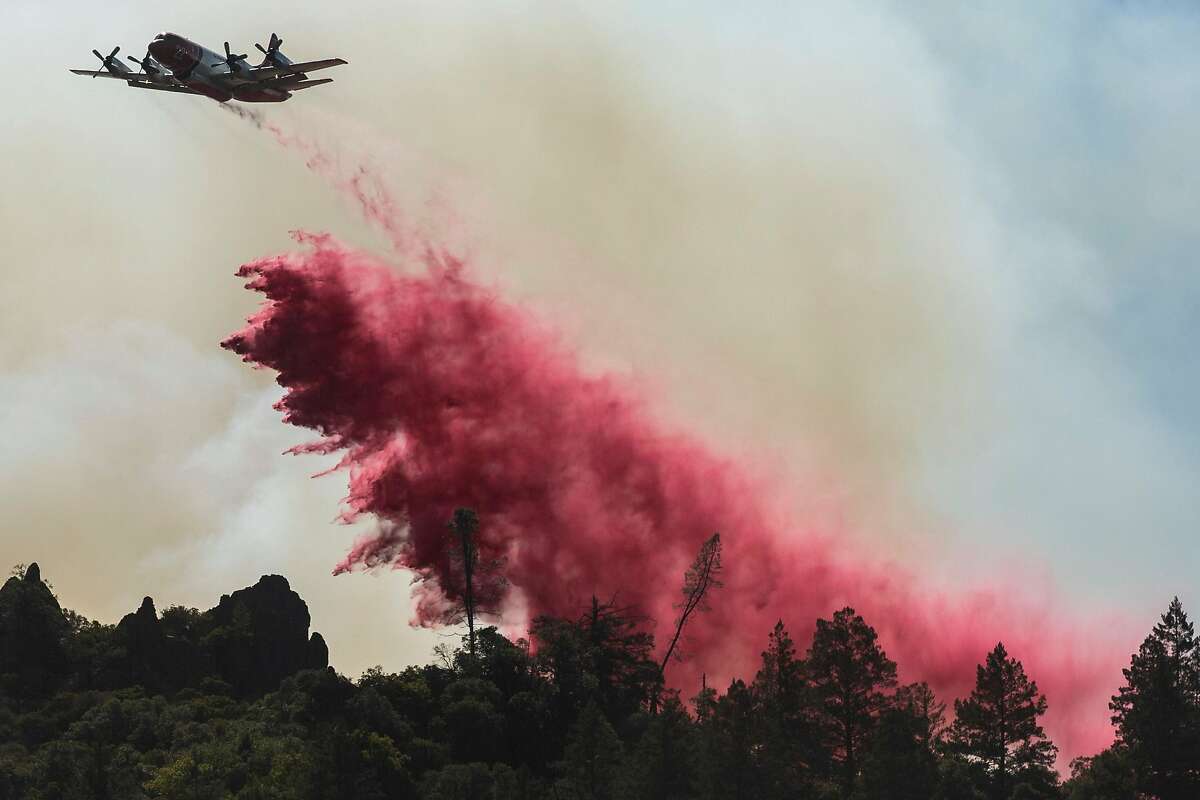 Aircraft release fire retardant in an attempt to prevent the Glass Fire from burning towards Highway 29 in the Calistoga area on Saturday.