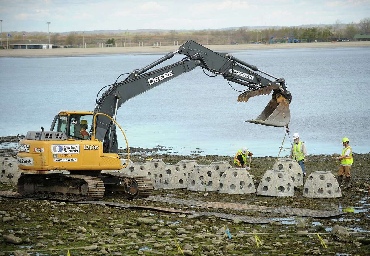 Concrete Reef Balls are guided into place during the installation of a "living shoreline" on the Audubon property on Stratford Point in Stratford, Conn. on Tuesday, May 6, 2014. Submerged at high tide, the barrier reduces storm erosion by dissipating the power of waves while at the same time provides living environments for tide zone fauna. “We are very pleased to see the Stratford Point Living Shoreline project receive this national recognition,” Mayor Laura Hoydick said in a prepared statement. “The Town of Stratford has been very supportive of this critical project and its ecological benefits, which we believe will result in lasting and meaningful change with how communities increase coastal resilience by promoting and preserving important natural habitats. I congratulate all the partners in this important project for receiving this well-deserved recognition.”