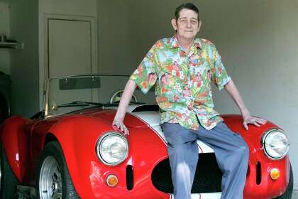 Rob La Gesse relaxes in the garage at home with his Cobra sports car on Oct. 2, 2020.