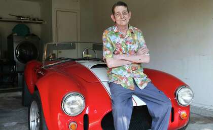 Rob La Gesse relaxes in the garage at home with his Cobra sports car on Oct. 2, 2020.
