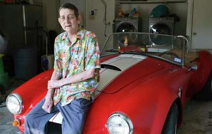 Rob La Gesse relaxes in the garage at home with his Cobra sports car on Oct. 2, 2020.