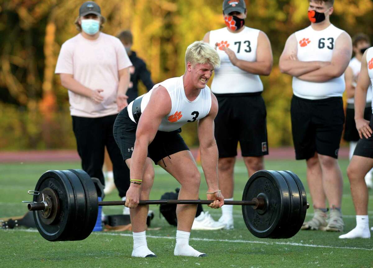 Ridgefield's Jackson Trotter competes in the deadlift during the strength challenge portion of Friday night's season-opening football contest against Wilton. A 7v7 passing game followed the strength challenge.
