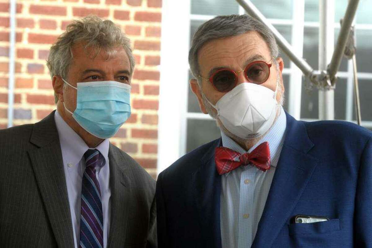 Mark Scheinberg, left, President of Goodwin University and John Petillo, President of Sacred Heart University speak prior to a news conference on the University of Bridgeport campus, in Bridgeport, Conn. June 30, 2020.