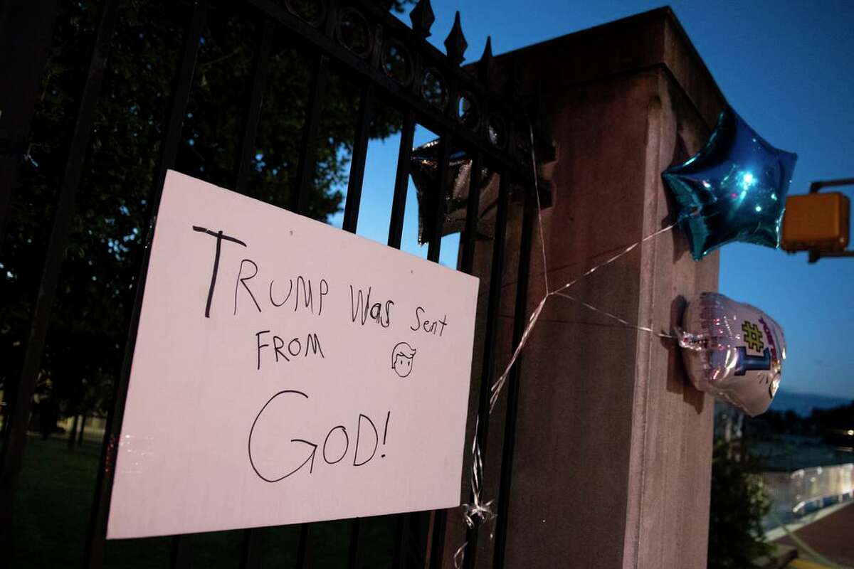 A sign on the fence, at the entrance, to Walter Reed National Military Medical Center in Bethesda, Md., Monday, Oct. 5. President Donald Trump was admitted to the hospital after contracting the coronavirus.