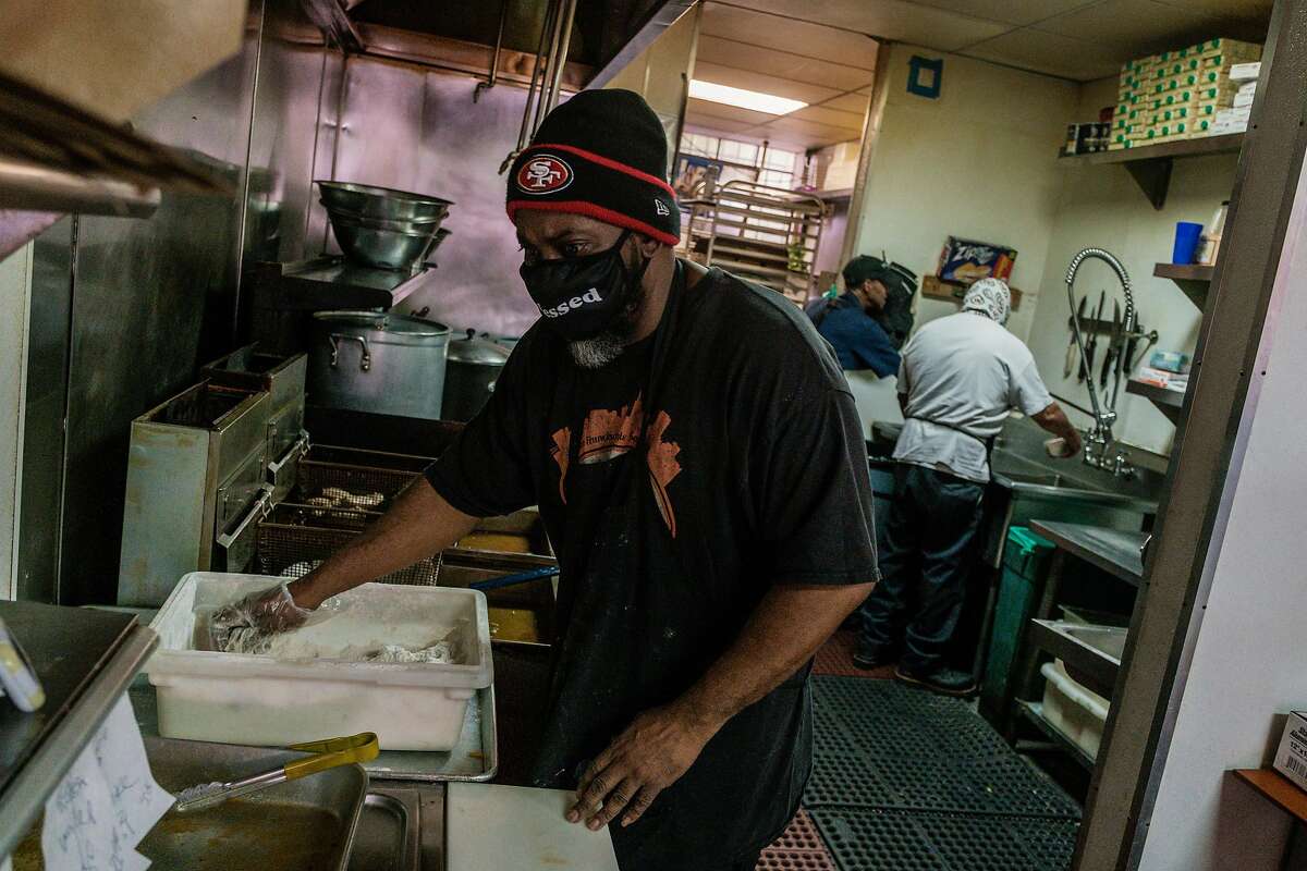 Marcel Banks prepares food at Frisco Fried in San Francisco on Thursday, October 1, 2020. Banks who is the owner of Frisco Fried is delaying opening up his restaurant to indoor dining even though all San Francisco restaurants can now seat people indoors at twenty-five percent capacity.