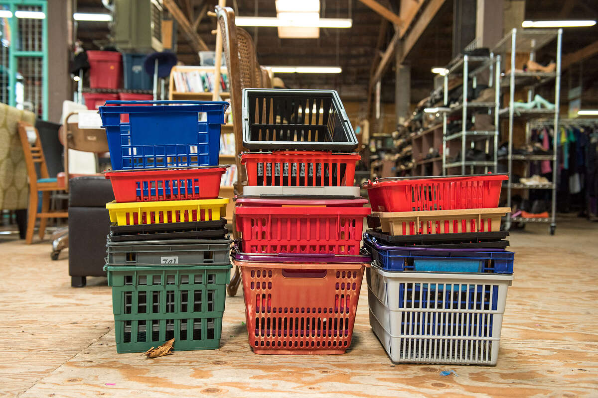 Freshly sanitized shopping baskets are stacked up and ready to use when customers walk through the steel garage door entryway of Community Thrift.