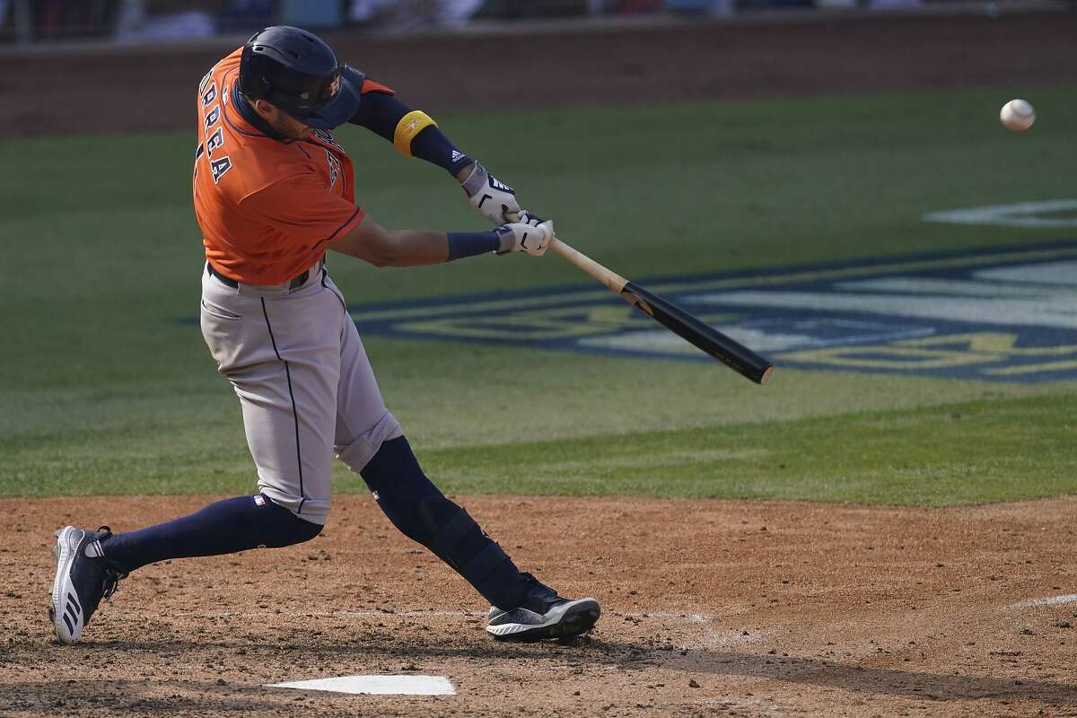 Houston Astros' Carlos Correa hits a solo home run against the Oakland Athletics during the seventh inning of Game 1 of a baseball American League Division Series in Los Angeles, Monday, Oct. 5, 2020.